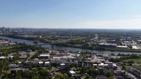 Aerial of Cumberland River flowing through residential and industrial Nashville Stock Footage 343593544