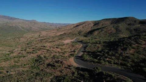 Aerial of a curvy empty road going through the desert Stock Footage 251834923