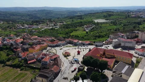 Aerial - Cyclists Racing Through Small Town Square Inflatable Apple Regua Stock Footage 336633631