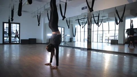 An aerial dancer is showcasing their impressive acrobatic skills within a Stock Footage 301395327