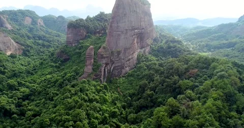 Aerial Danxia Landform Mountains Surrounded by Tropical Forest Video stock 342017836