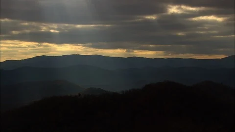 Aerial of dark clouds above mountain peak at dusk, Dramatic cloudy sky Stock Footage 109140489