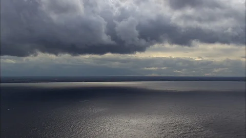 Aerial of dark clouds over the calm sea, Moody clouds over water, New York State Stock Footage 109138106
