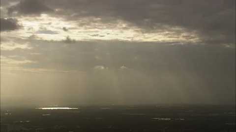 Aerial of dark clouds over the landscape at the dusk, God-like rays shining down Stock Footage 109143431