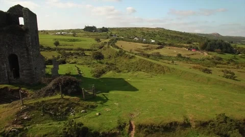 Aerial daytime close up side flyby of derilict Tin Mine on moorland shot Video stock 64994891