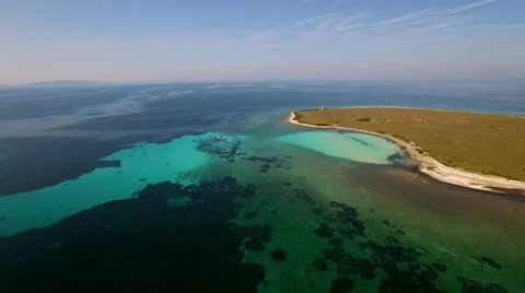 Aerial - Decay of algae during algal blooms at small sea island Stock Footage 56249547