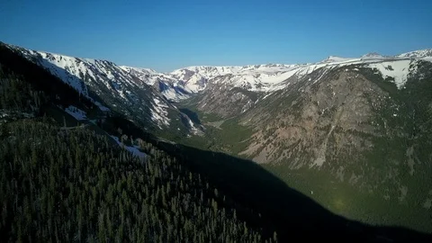 Aerial of deep valley in shadow casted by surrounding mountains Stock Footage 124226280