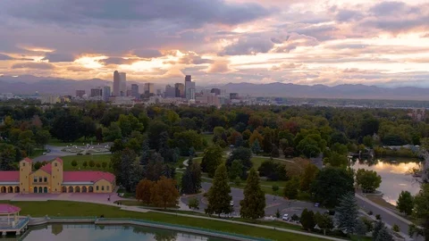 Aerial - Denver skyline with mountains in background at sunset Stock Footage