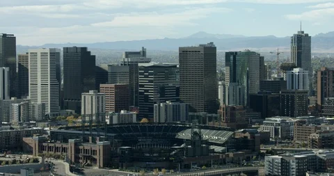 Aerial of Denver stadium surrounded with high-rise buildings in the city Stock Footage 96455259