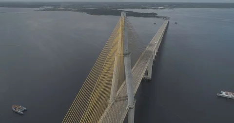 Aerial descending beside the cable-stayed Rio Negro Bridge that links the cities 스톡 동영상 101293702