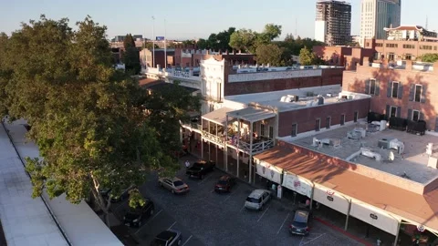 Aerial descending close-up shot of various storefronts and businesses Stock Footage 201994765