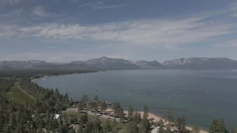 Aerial Descending Shot from Lake into Trees: Stunning Natural Transition Stock Footage 263798853