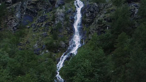 Aerial descending view of a mountain stream of water in the Italian Alps Stock Footage 112006758