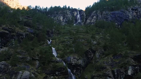 Aerial descending view of a mountain stream of water in the Italian Alps Stock Footage 113901792