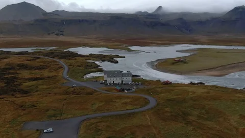 Aerial descending view over a small black church and a graveyard in West Iceland Stock Footage 115712136