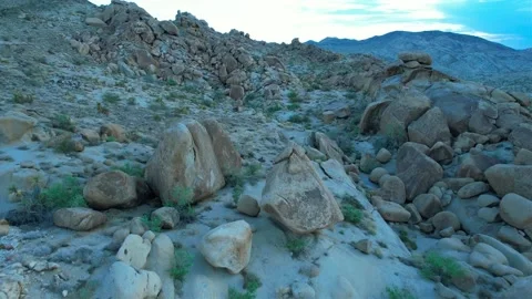 Aerial descent down a mountainside with large rock formations and boulders Stock Footage 205048769