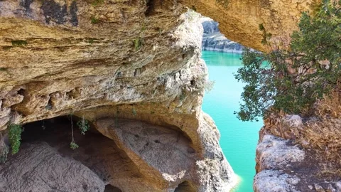 Aerial Descent Into Dramatic Canyon with Turquoise Lake and Golden Grass Stock-Footage 340106955