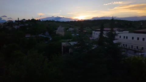 Aerial Descent Past Pine Trees Revealing Historic Mosque and Madrasa at Sunset Stock Footage 339697669