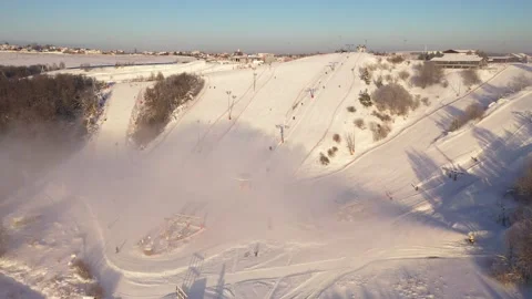 Aerial diagonal approach to bright winter ski area Vidéo 322641695