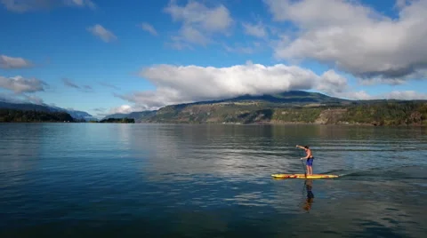 Aerial diagonal push forward of standup paddler boarder "SUP". Stock Footage 68801982