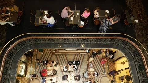 Aerial diners checking phones in elegant shopping mall 6K Stock Footage 325829605