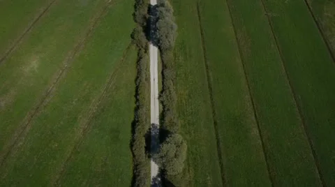 AERIAL: Dirt road through fields Stock Footage 21244388