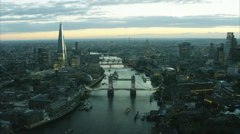 Aerial distant sunset view of the River Thames and city skyline of London UK Stock Footage