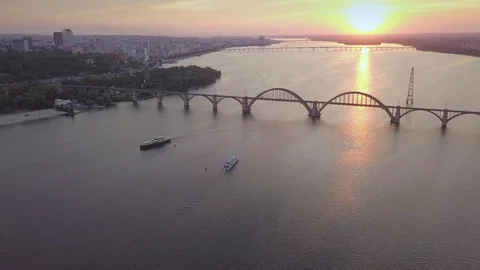 Aerial distant sunset view of the River Dnipro, flying over the river and ships Stock Footage 102433100