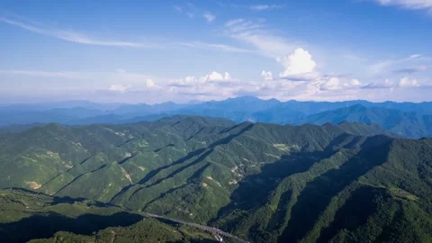 Aerial distant view of continuous layered mountain range wide mountain forest Stock Footage 337925503