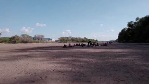 Aerial DJI Drone, Low angle Shot People in the Desert of Turkana County Video stock 243683415