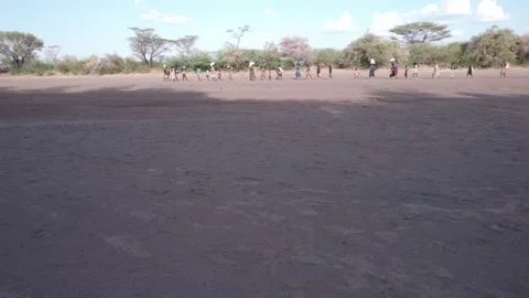 Aerial DJI Drone, Wide Panning Left People Walking in the Desert of Turkana Stock Footage 243683653