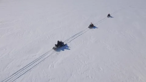 Aerial dog sled team pulling people through winter snow Husky sledding North 4k Stock Footage 317963138