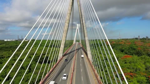 Aerial dolly back motion from the cable-stayed bridge. Cars and trucks driving Stock Footage 245569342