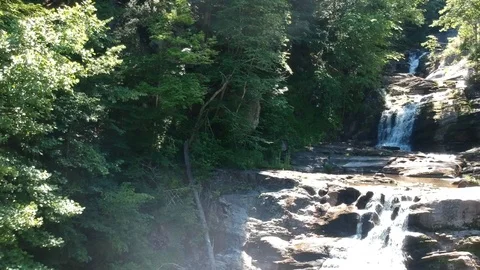 Aerial dolly back revealing multiple waterfalls and visitors / tourists Stock Footage 112889109