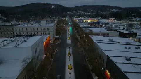 Aerial dolly backwards reverse reveal of small town America in snow. Main Stock Footage 227130644