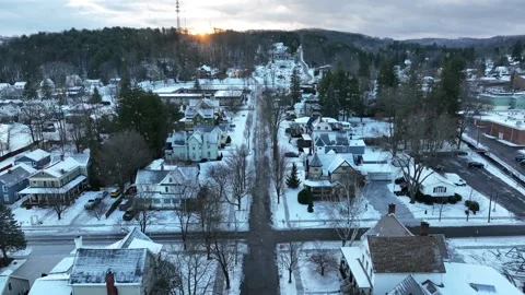 Aerial dolly forward of snow falling on quaint small town in America. Stock Footage 230406599