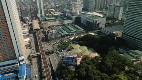 Aerial Dolly Over EDSA, MRT Line, and Shopping Malls in Araneta City, Cubao Stock Footage 339766837