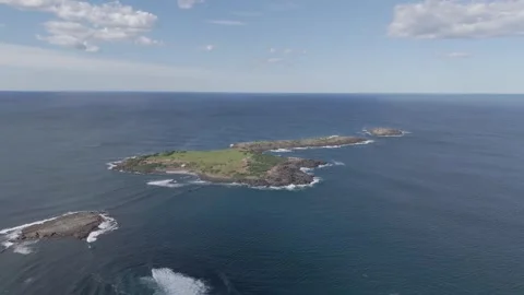 Aerial dolly to remote low tropical rocky island with grassy patch and Video stock 285377626