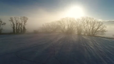 Aerial dolly shot amazing foggy winter morning sunrise over farm fields Stock Footage