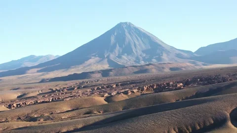 Aerial dolly shot, moving down the mountain, of the volcano Volcan Licancabur Stock Footage 162311301