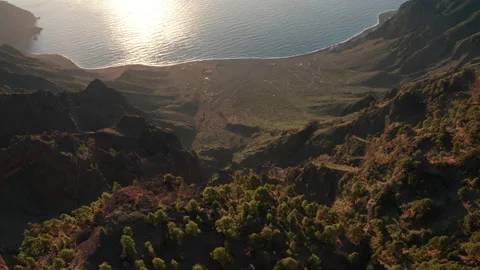 Aerial dolly tilt down over sunlit caldera Las Playas of ocean coast Stock Footage 170605014