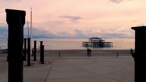 Aerial dolly view of the destroyed West Pier in Brighton at sunset Stock Footage 106397938