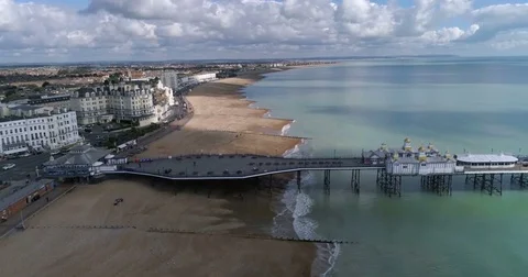 Aerial dolly view of the seafront and the Victorian pier in Eastbourne Stock Footage 81729653