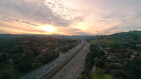 Aerial - DOUBLE SUN Sunset Over Traffic in a Small Town in NorCal Video stock 87671953