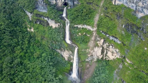 Aerial double waterfall dropping from cliff in green forest Stock Footage 331410645