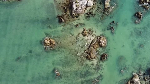 Aerial down view of waves over beautiful rocks by the beach in Langkawi Malaysia Stock Footage 156939417