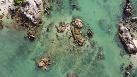 Aerial down view of waves over beautiful rocks by the beach in Langkawi Malaysia Stock Footage 156939437