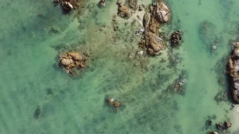 Aerial down view of waves over beautiful rocks by the beach in Langkawi Malaysia Video stock 156939472
