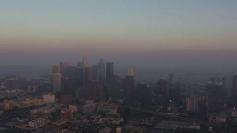 Aerial of downtown Los Angeles during golden hour, smog settling over buildings Video stock 208751653