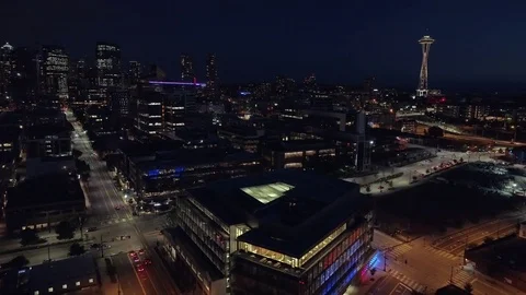 Aerial of Downtown Seattle Lit at Night with Cars Driving on City Streets Stock Footage